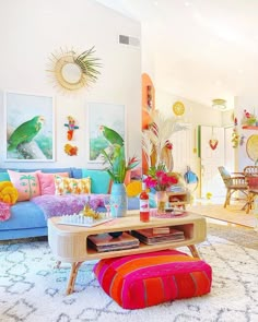 a living room filled with lots of colorful furniture and decor on top of a rug