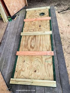 some boards are laying on the ground and ready to be used as a planter