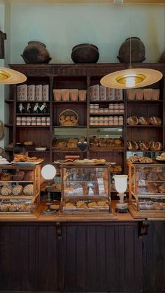 a bakery filled with lots of different types of breads and pastries on display