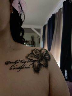 a woman with a flower tattoo on her chest