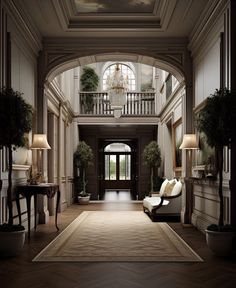 an elegant entry way with two couches and lamps on either side of the door