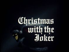 the words christmas with the joker are lit up in the dark, and there is only one light on