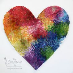 a colorful heart made out of small beads