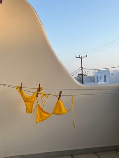 yellow cloths are hanging on a clothes line