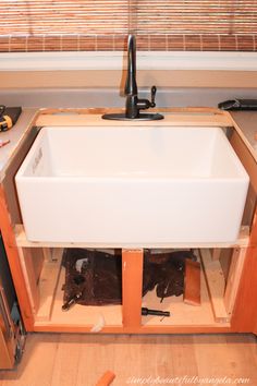 an unfinished kitchen sink in the middle of construction