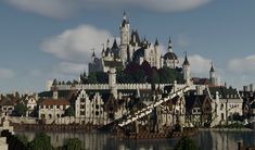 a large castle sitting on top of a hill next to a body of water in front of a cloudy sky