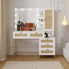 a white vanity with lights on it next to a bed in a room filled with furniture