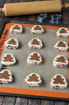 some cookies are on a cookie sheet with sprinkles