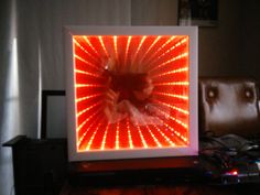 an image of a person's reflection in a light box with red and white lights