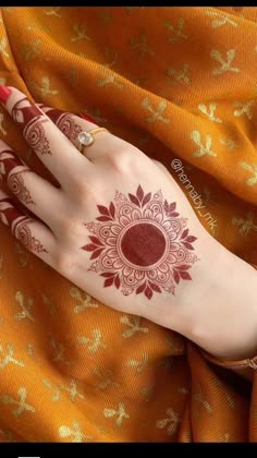 a woman's hand with henna tattoos on it