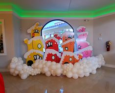 balloons are arranged in the shape of houses and castles on display at a children's birthday party