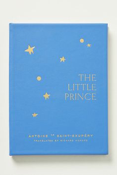 a blue book with gold stars and the title'the little prince'on it