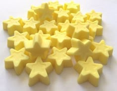 many yellow stars are arranged on a white surface