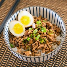 a bowl filled with rice, meat and an egg