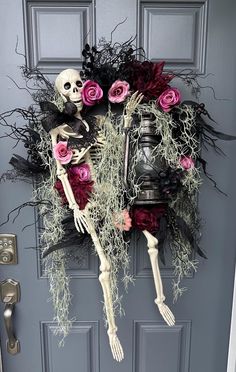 a door decorated with fake skeletons and flowers