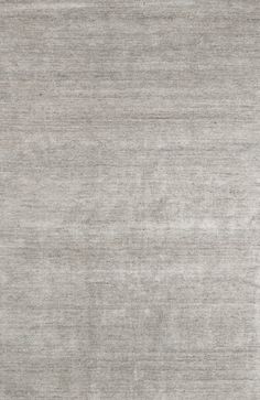 an area rug that has been made with light gray colored wool and is very soft