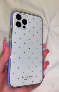 a person holding a cell phone case with diamonds on the front and back cover in their hand