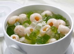 a white bowl filled with food on top of a table