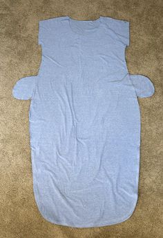 a blue shirt laying on top of a brown carpet