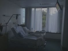 an empty hospital room with a bed in it