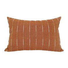 an orange and white striped pillow on a white background, with small dots in the middle