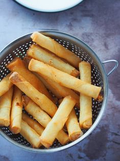 some food is in a colander on the table