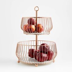 three tiered metal fruit stand with apples in it