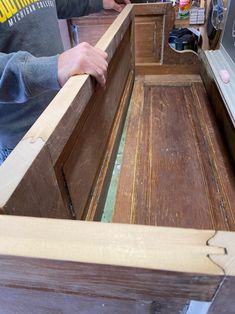 two men are working on an unfinished cabinet