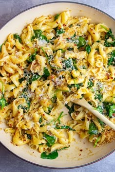 pasta with spinach and parmesan cheese in a skillet