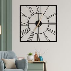 a living room with a blue chair and a large clock on the wall above it