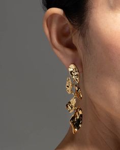 "Find ALEXIS BITTAR Mosaic Molten Post Earrings on Editorialist. Details Rich 14k gold plated metalwork is sculpted to create a cascade of abstract petals on these 1950s modernist inspired post earrings. Designed to allow the delicate petals to swing with movement. 14k gold plated brass, surgical steel ear posts Clear disc earring back UPC: 889519124168 Measurements 2.75\" length x .75\" width Care To clean your molten gold leaf drop earrings, gently wipe the surface with a soft cloth. For additional care instructions visit our FAQ page. FAQs What are the materials that make up these molten gold leaf drop earrings? The materials that are used in these molten gold leaf drop earrings are signature materials of the Alexis Bittar jewelry collection. Combinations of crystals and custom metalwor Bridal Era, Molten Gold, Alexis Bittar Jewelry, Metalwork Jewelry, Disc Earrings, Earrings In Gold, Alexis Bittar, Earring Backs, Gold Leaf