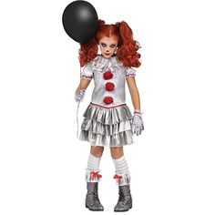 a girl dressed as a clown holding a black balloon