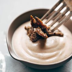 a fork in a bowl with some food on it