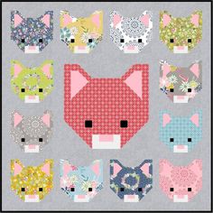 a cat quilt with many different colors and patterns on the front, including pink, blue,