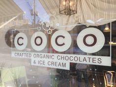 a store front window with the words coco written on it