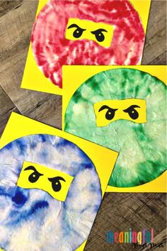 three different colored paper plates with faces on them and one has eyes painted on it