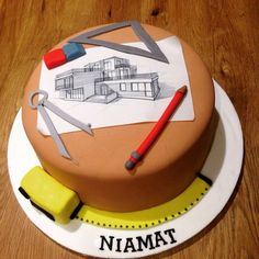 a cake that has been decorated to look like a house with scissors and pencils on it