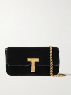 There's a reason velvet lines jewelry boxes - it accentuates the luster of hardware gorgeously. TOM FORD's clutch drapes from a chain strap and fastens with a gilded 'T' charm that both gleam under light. It'll hold small essentials like a phone, lipstick and cardholder. Tom Ford Jewelry, Tom Ford Bag, Velvet Clutch, Exclusive Dress, Sport Swimwear, Fine Jewelry Designers, Jewelry Boxes, Summer Hats, Clothes Collection