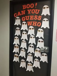 a door decorated with ghost faces and words that say boo can you guess who?