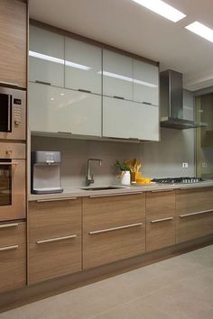 a kitchen with wooden cabinets and stainless steel appliances