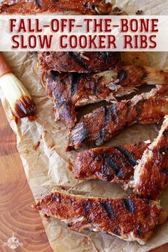 barbecue ribs with bbq sauce and a brush on a piece of wax paper next to it