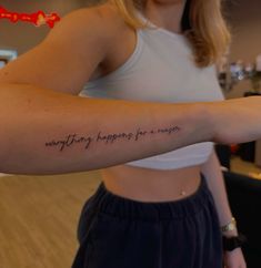 a woman with a tattoo on her arm saying everything happens for a reason in cursive writing