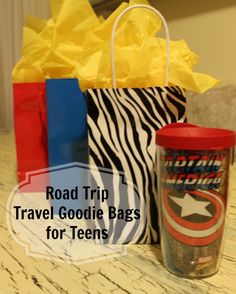 the road trip travel goodie bags for teens are on display in front of a cup