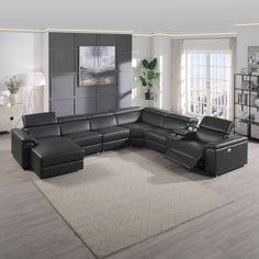 a living room with a large sectional couch in the middle and a rug on the floor