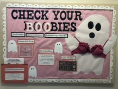 a bulletin board that has been decorated to look like a ghost and says, check your booies