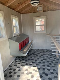 the inside of a small building with stairs and windows