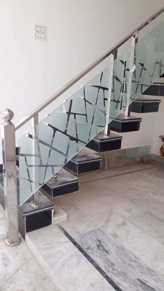 a set of stairs with glass railings