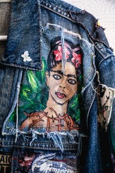 a jean jacket with an image of a woman's face on it