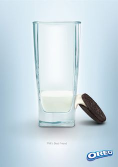 an oreo cookie is next to a glass of milk