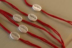 four red string with silver discs on them